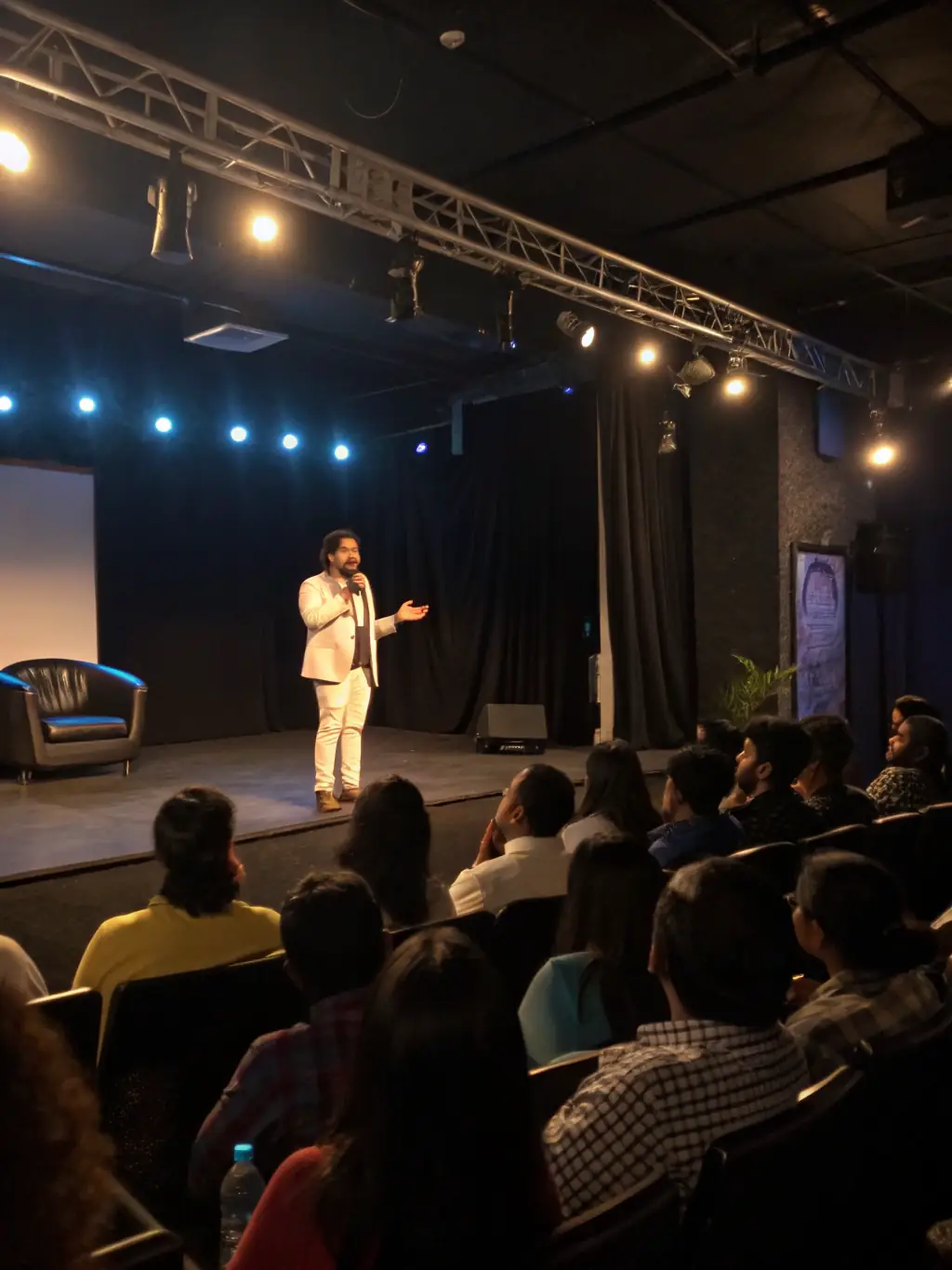 A photograph capturing the energy of a leadership summit in Mumbai, India, with attendees actively participating in a panel discussion.
